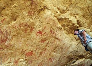 The Ennedi Massif, members of the expedition in front of prehistoric rock art, Explore Chad
