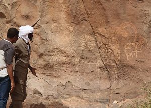 The Ennedi Massif, members of the expedition in front of prehistoric engravings, Explore Chad
