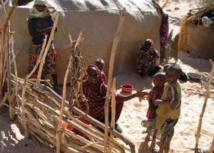 The Ennedi Massif, women and children in front of a hut, Explore Chad
