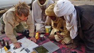 Expedition to Ounianga, members of the expedition studying maps of the region on the laptop, Explore Chad