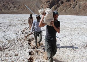 The Tibesti Mountains, Trou au Natron, members of the expedition carrying samples and walking on a crusty layer of salt, Explore Chad